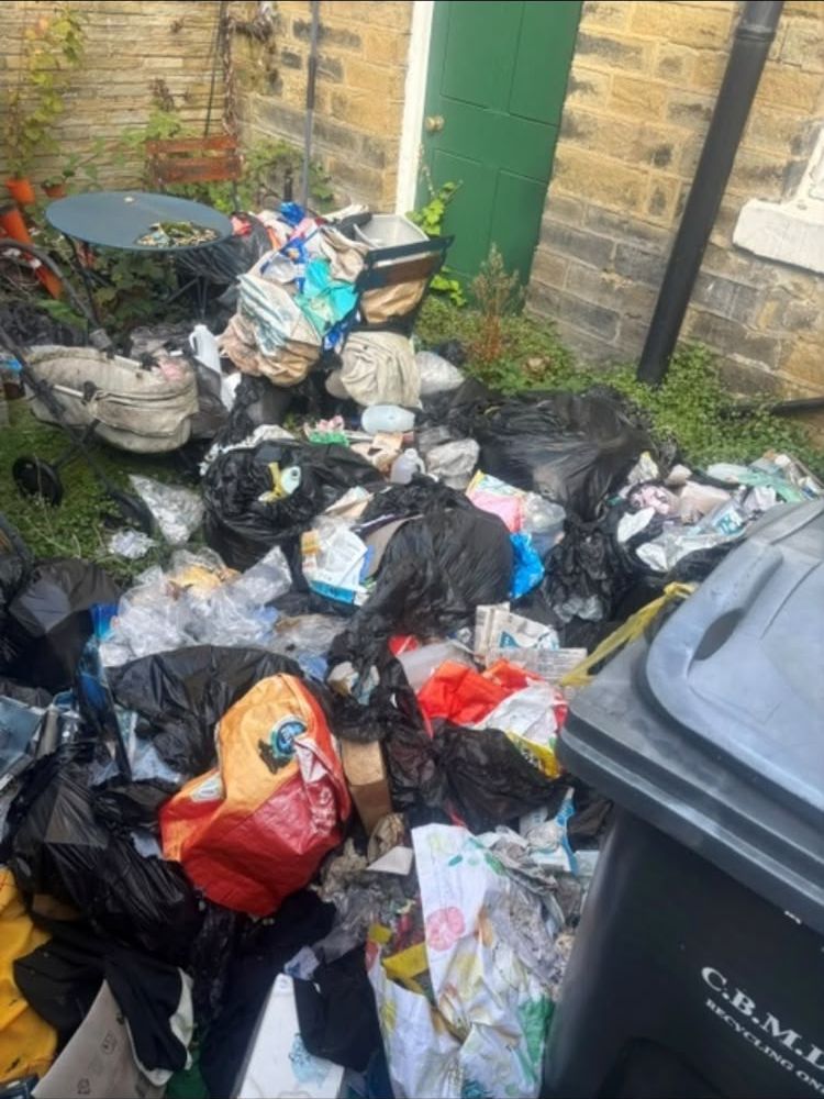 Before: Back yard clearance: bags, junk and garden waste removed